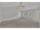 Bright main bedroom featuring vaulted ceilings, neutral carpet and paint, ceiling fan, and lots of natural light at 418 Old Scarborough Ln, Garner, NC 27529
