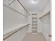 Walk-in closet featuring wood shelving and carpeted floors at 418 Old Scarborough Ln, Garner, NC 27529