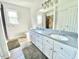 Bright bathroom with a double sink vanity and a tile shower at 4200 Harmony Church Rd, Efland, NC 27243