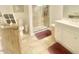 Well-lit bathroom featuring double sinks, tiled floors, and a glass-enclosed shower at 4200 Harmony Church Rd, Efland, NC 27243