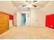 Bedroom with ceiling fan, large closet doors, and vibrant red accents at 4200 Harmony Church Rd, Efland, NC 27243