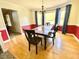 Inviting dining room with hardwood floors, large windows, and elegant lighting at 4200 Harmony Church Rd, Efland, NC 27243