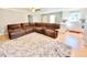 Open living space with a large sectional sofa and access to kitchen at 4200 Harmony Church Rd, Efland, NC 27243
