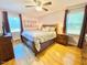 Spacious main bedroom with hardwood floors, a king-sized bed, and plenty of natural light at 4200 Harmony Church Rd, Efland, NC 27243