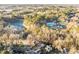 Aerial view of the neighborhood featuring a lake, swimming pool and lush green trees at 4401 Liverpool Ln, Raleigh, NC 27604