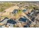 Expansive aerial view of a property featuring an access road, landscaping, and adjacent community at 4401 Liverpool Ln, Raleigh, NC 27604