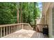 Wooden back deck surrounded by lush trees, offering a relaxing outdoor space at 4401 Liverpool Ln, Raleigh, NC 27604