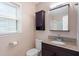 Bathroom with dark wooden cabinets, granite countertops, shower and tile flooring at 4401 Liverpool Ln, Raleigh, NC 27604