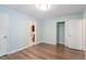 Bedroom features hardwood floors, blue walls, a closet, and access to the bathroom at 4401 Liverpool Ln, Raleigh, NC 27604