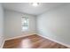 A light blue bedroom featuring hardwood floors and a window to let in natural light at 4401 Liverpool Ln, Raleigh, NC 27604