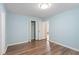 Bedroom offers hardwood floors, blue walls, a closet, and a bright window at 4401 Liverpool Ln, Raleigh, NC 27604