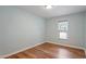 This bedroom features hardwood floors and a window letting in natural light at 4401 Liverpool Ln, Raleigh, NC 27604