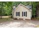 A well-maintained home featuring a concrete driveway, a brick foundation, and neutral siding at 4401 Liverpool Ln, Raleigh, NC 27604