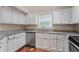 Bright kitchen with granite countertops, white cabinets, and stainless steel appliances at 4401 Liverpool Ln, Raleigh, NC 27604