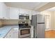 Well-equipped kitchen with stainless steel appliances, granite countertops, and modern white cabinetry at 4401 Liverpool Ln, Raleigh, NC 27604