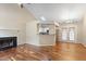 Open living room featuring hardwood floors, a fireplace, and a bright skylight at 4401 Liverpool Ln, Raleigh, NC 27604
