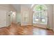 Inviting space with gleaming hardwood floors and a large window to enjoy natural light at 4401 Liverpool Ln, Raleigh, NC 27604