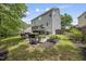 Lush backyard featuring a patio, landscaping, flower beds, and mature trees at 507 Littleport Dr, Rolesville, NC 27571