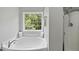 Bathroom featuring a soaking tub with window view, plus glass enclosed shower at 507 Littleport Dr, Rolesville, NC 27571