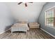 Cozy bedroom features a daybed, ceiling fan, and large window at 507 Littleport Dr, Rolesville, NC 27571