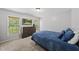 Carpeted bedroom with a window view, large dresser, and wall-mounted television at 507 Littleport Dr, Rolesville, NC 27571