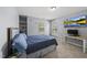 Bedroom with a blue color scheme, built-in shelving, desk, and large television at 507 Littleport Dr, Rolesville, NC 27571