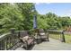 Inviting deck with wicker seating and a small table overlooking green trees at 507 Littleport Dr, Rolesville, NC 27571