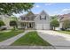 Charming two-story home with a stone facade, covered porch, and attached two-car garage at 507 Littleport Dr, Rolesville, NC 27571