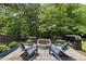 Inviting stone fire pit surrounded by Adirondack chairs and lush landscaping at 507 Littleport Dr, Rolesville, NC 27571
