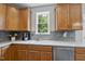 Bright kitchen features wood cabinets, stainless steel dishwasher, and natural light at 507 Littleport Dr, Rolesville, NC 27571
