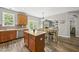 Open kitchen with island, stainless steel appliances, and dining area leading to a spacious living room at 507 Littleport Dr, Rolesville, NC 27571