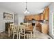 Open kitchen boasts stainless steel appliances and wood cabinets next to a dining area at 507 Littleport Dr, Rolesville, NC 27571