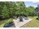 Relaxing patio area with pavers, a fire pit, chairs, and a grill perfect for entertaining at 507 Littleport Dr, Rolesville, NC 27571