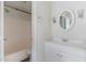 Bathroom with tub-shower combo, new white vanity and decorative mirror and sconces at 5073 Tall Pines Ct, Raleigh, NC 27609