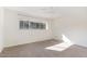 Bright bedroom with a large window and neutral carpeting, features ceiling fan at 5073 Tall Pines Ct, Raleigh, NC 27609