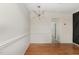 Dining room features hardwood floors, modern light fixture, and an adjacent room at 5073 Tall Pines Ct, Raleigh, NC 27609