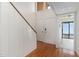 Bright foyer features hardwood floors, staircase, closet, and entry to additional room at 5073 Tall Pines Ct, Raleigh, NC 27609