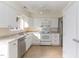 Well-lit kitchen with white cabinets and stainless steel appliances at 5073 Tall Pines Ct, Raleigh, NC 27609