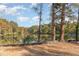 Scenic view of lake through mature trees, with construction visible in the foreground at 5073 Tall Pines Ct, Raleigh, NC 27609