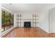 Bright living room with hardwood floors, fireplace and shelving and natural light at 5073 Tall Pines Ct, Raleigh, NC 27609