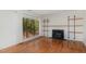 Bright living room with hardwood floors, fireplace and shelving and natural light at 5073 Tall Pines Ct, Raleigh, NC 27609