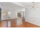 Spacious living room with hardwood floors, fireplace, shelving, and dining space at 5073 Tall Pines Ct, Raleigh, NC 27609
