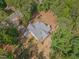 Aerial view of a home, showcasing its architectural design, backyard, and surrounding wooded landscape at 5163 S River Rd, Lillington, NC 27546