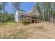 A large deck and patio, coupled with a fire pit enhance the spaciousness of the backyard at 5163 S River Rd, Lillington, NC 27546