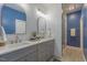 Charming bathroom featuring double sinks, gray cabinets, and updated shower at 5163 S River Rd, Lillington, NC 27546
