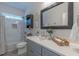 Well-lit bathroom with modern vanity, stylish mirror, and tub-shower combination at 5163 S River Rd, Lillington, NC 27546