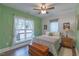 Serene bedroom with a green wall, ample natural light, and relaxing decor at 5163 S River Rd, Lillington, NC 27546