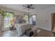 Bright bedroom with wood floors, ceiling fan, and ensuite bath at 5163 S River Rd, Lillington, NC 27546