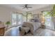 Bright bedroom with hardwood floors, french doors to the deck, and lots of natural light and leafy decor at 5163 S River Rd, Lillington, NC 27546