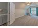 Carpeted bonus room with a ceiling fan, ensuite bathroom, and window with natural light at 5163 S River Rd, Lillington, NC 27546
